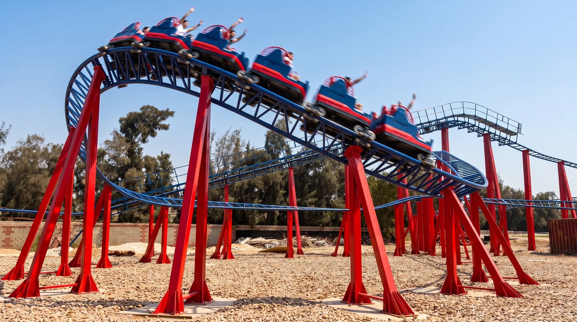 The TANZA rollercoaster train cresting the first bend, riders with their arms up