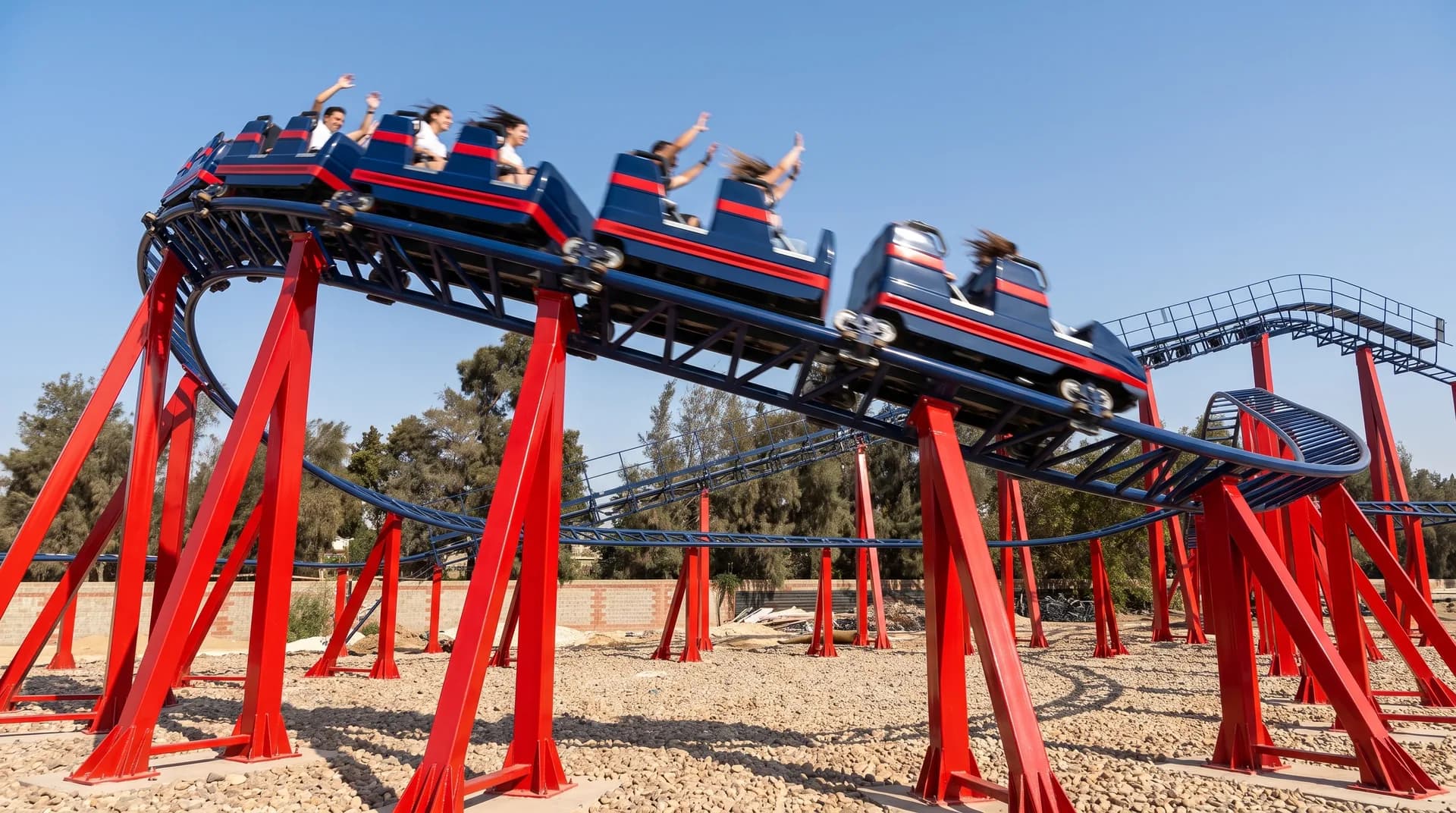 The train running the straight, red supports carrying the blue track