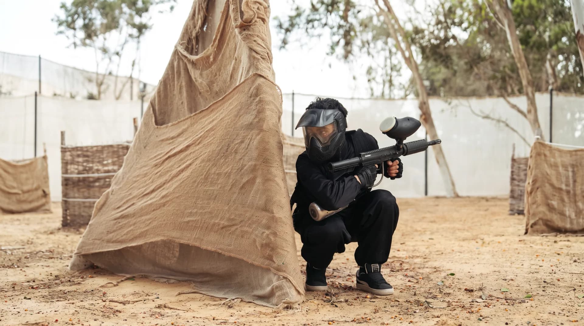 Paintball player behind cover